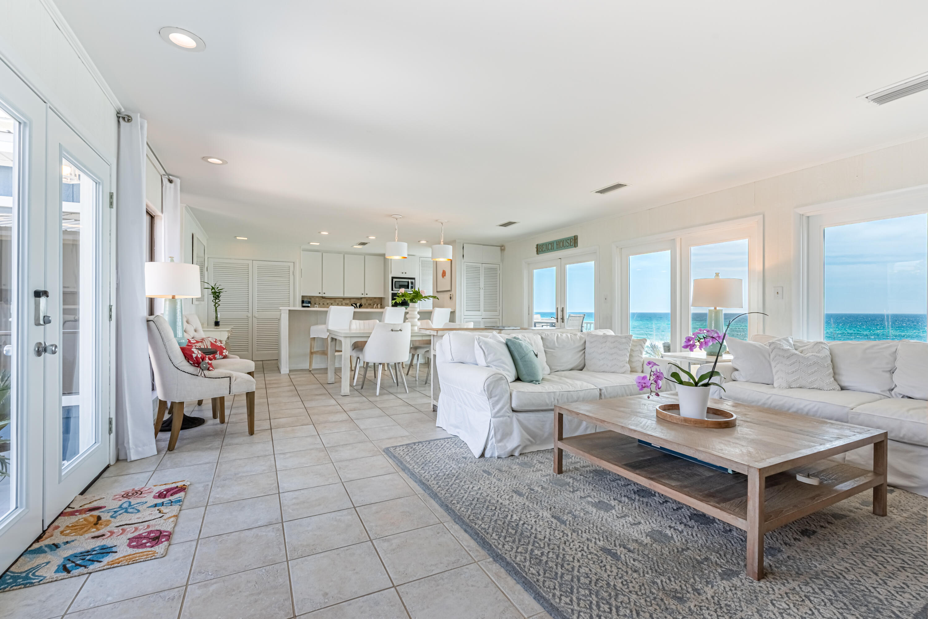 4731 West County Highway 30A Santa Rosa Beach, FL 32459 - Photo 9 of 44 a living room with furniture and a dining table with kitchen view