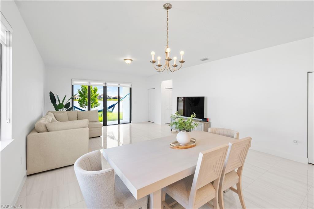 4951 Brigata Way Avenue Immokalee, FL 34142 - Photo 13 of 49 a view of a dining room with a table and chairs