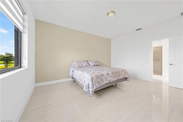 a bedroom with a bed and a dresser in it