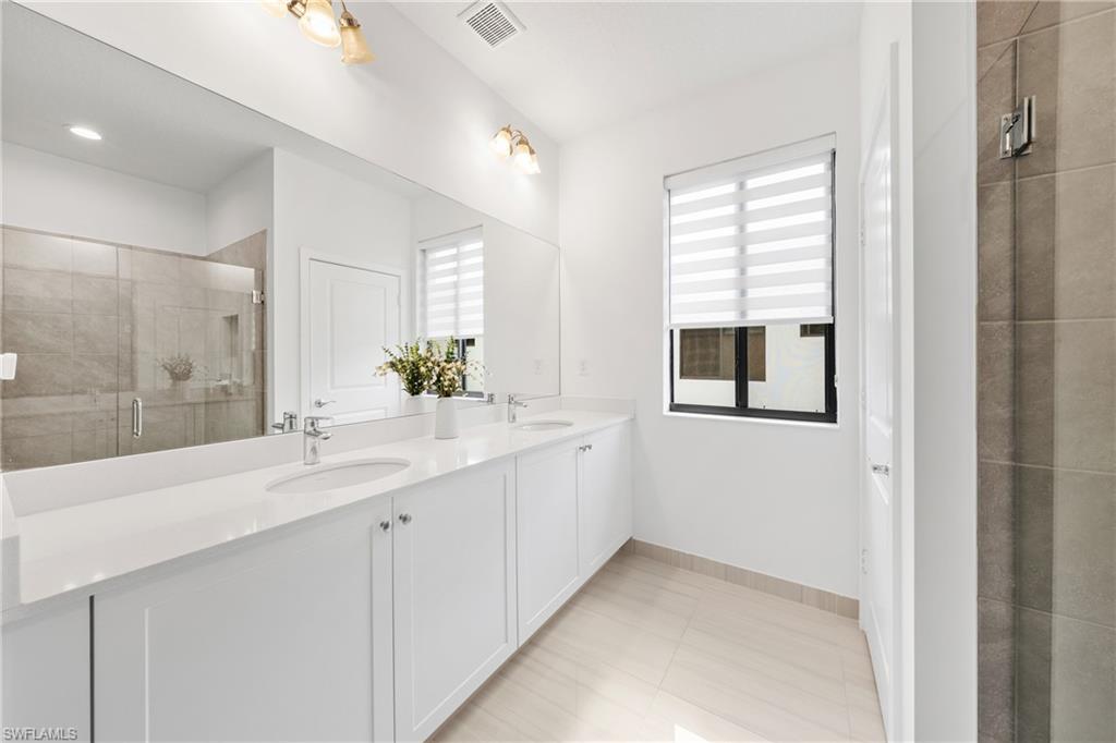 4951 Brigata Way Avenue Immokalee, FL 34142 - Photo 16 of 49 a bathroom with a sink and a mirror