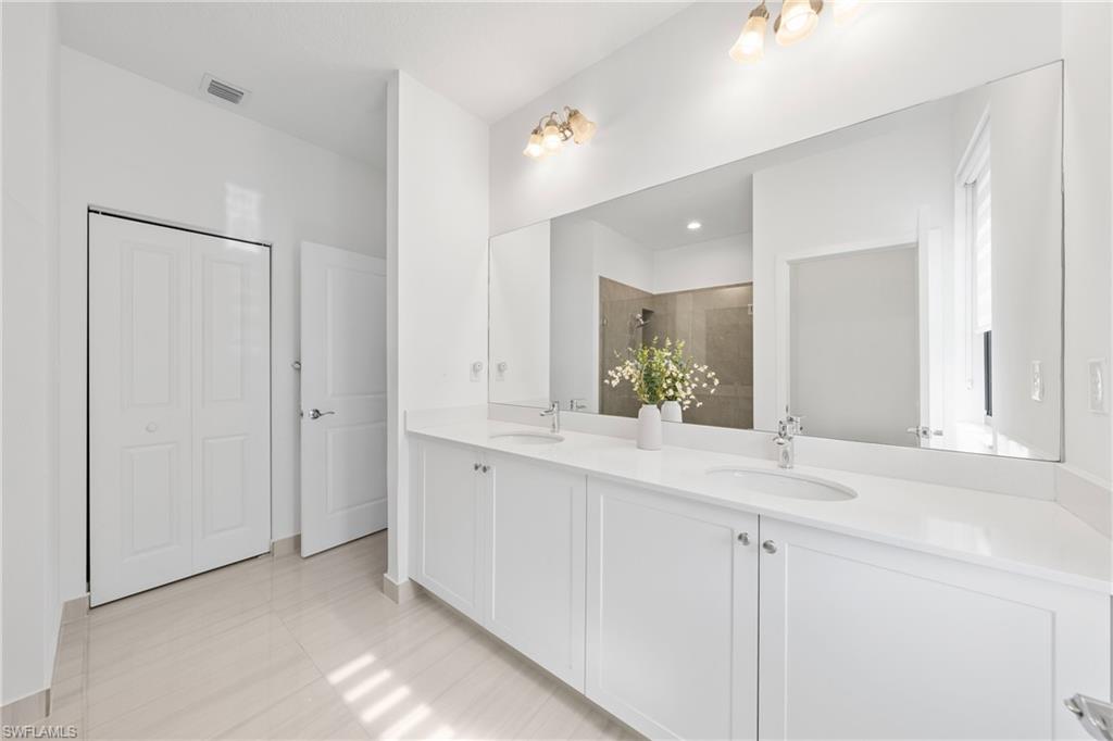 4951 Brigata Way Avenue Immokalee, FL 34142 - Photo 17 of 49 a bathroom with a sink and a mirror