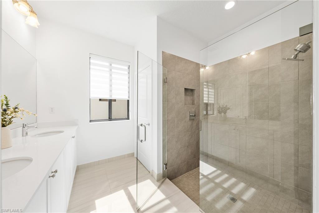 4951 Brigata Way Avenue Immokalee, FL 34142 - Photo 18 of 49 a bathroom with a sink and shower