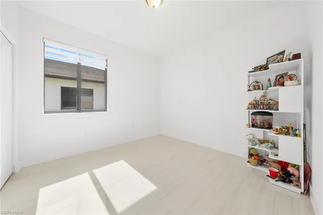 a bedroom with a bed and painting on the wall