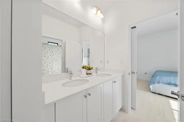 a bathroom with a sink double vanity and a mirror