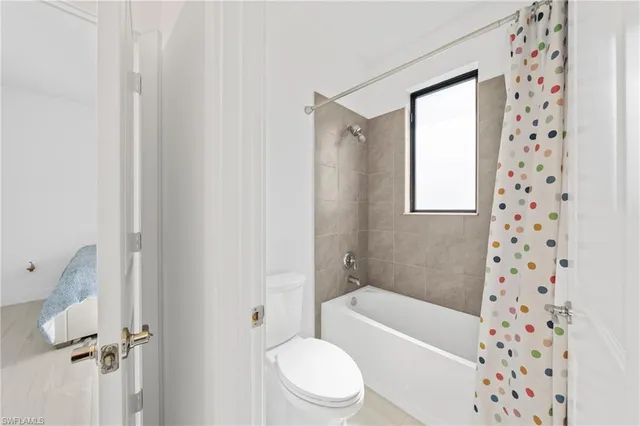 a bathroom with a toilet and a bathtub