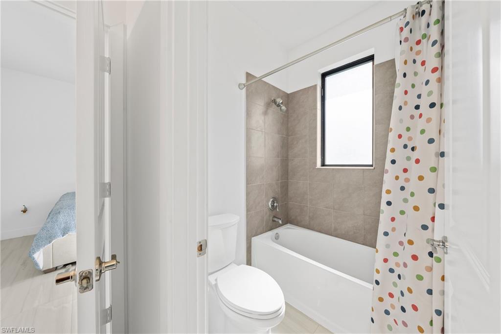 4951 Brigata Way Avenue Immokalee, FL 34142 - Photo 23 of 49 a bathroom with a toilet and a bathtub