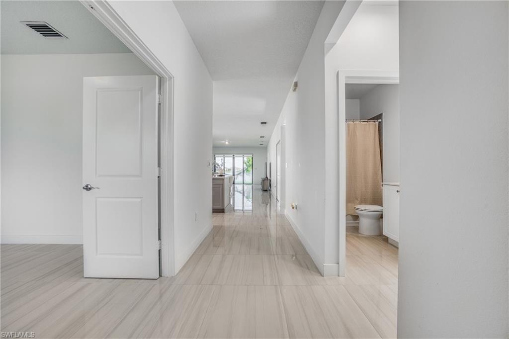4951 Brigata Way Avenue Immokalee, FL 34142 - Photo 24 of 49 a view of a hallway with wooden floor and closet