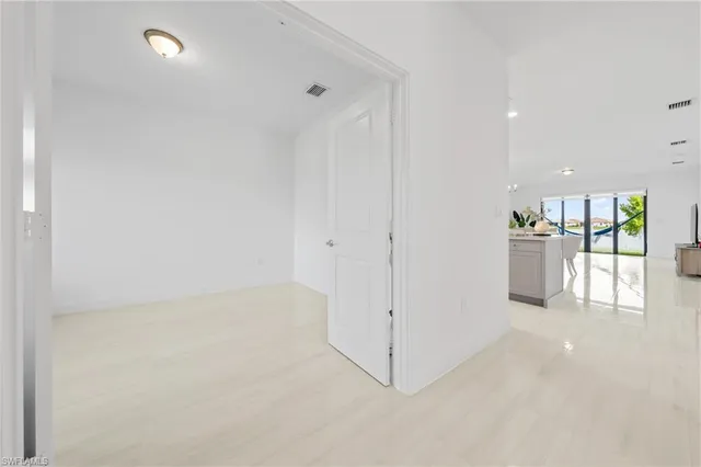 a view of a kitchen with a refrigerator and a sink