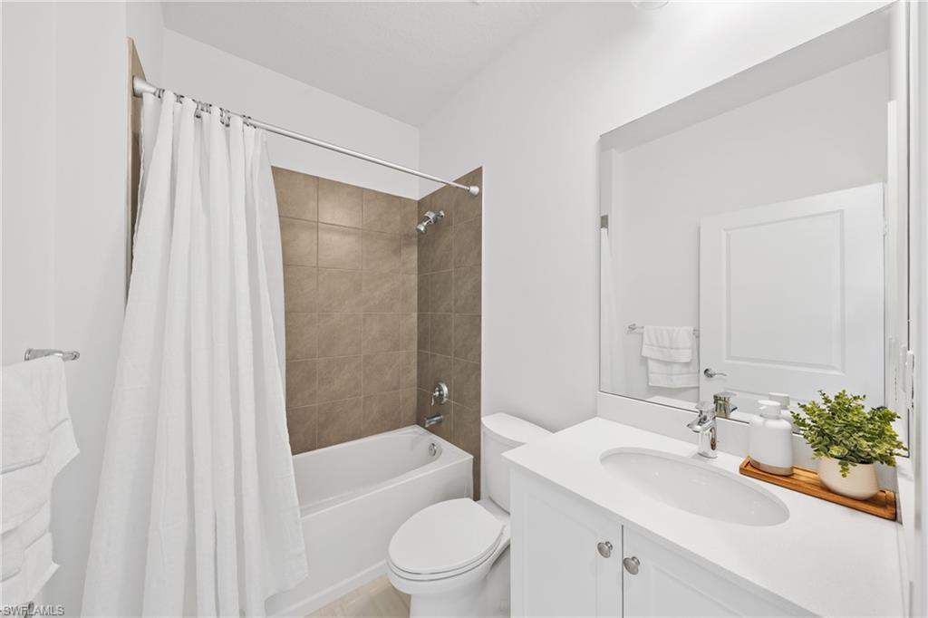 4951 Brigata Way Avenue Immokalee, FL 34142 - Photo 28 of 49 a bathroom with a sink toilet and shower