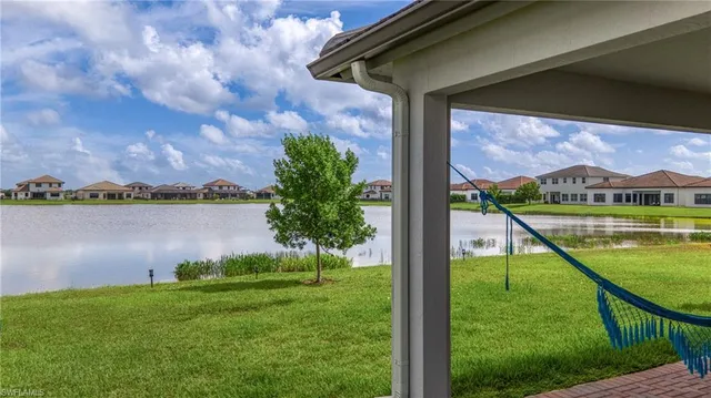 a view of an house with backyard and a patio