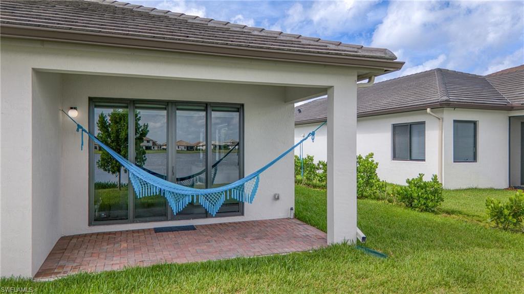 4951 Brigata Way Avenue Immokalee, FL 34142 - Photo 31 of 49 a view of an house with backyard and a patio