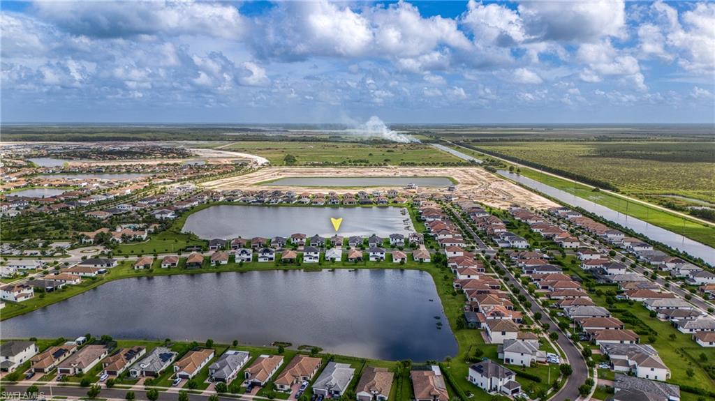 4951 Brigata Way Avenue Immokalee, FL 34142 - Photo 34 of 49 a view of a lake with a building in the background