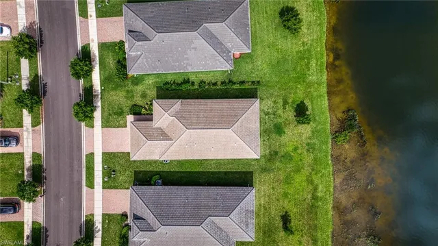 a view of a multi story building in a yard with palm trees