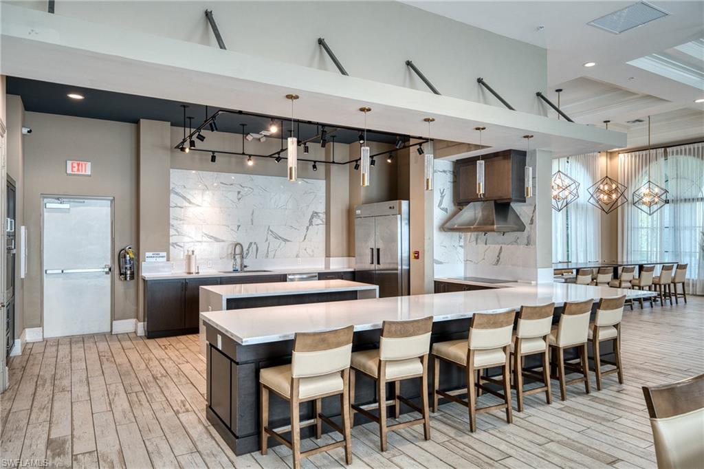 4951 Brigata Way Avenue Immokalee, FL 34142 - Photo 44 of 49 a large kitchen with a table and chairs