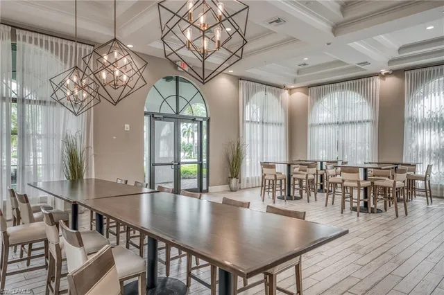 a living room with patio furniture and a flat screen tv