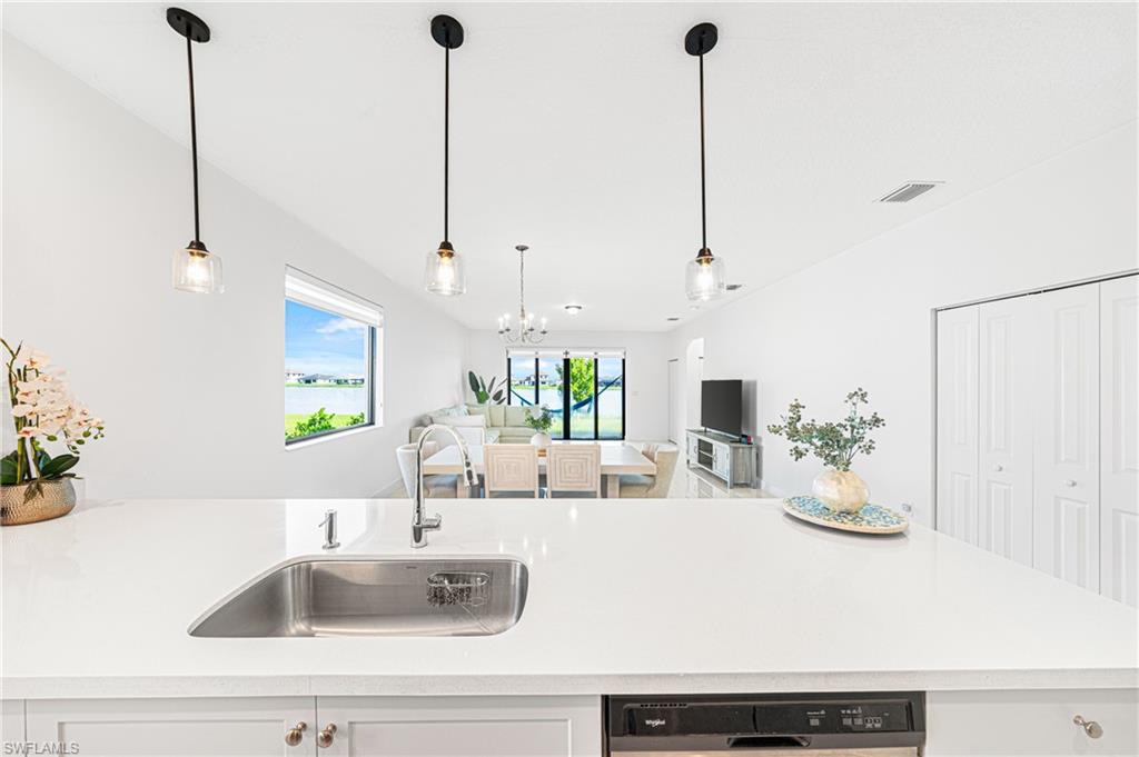 4951 Brigata Way Avenue Immokalee, FL 34142 - Photo 49 of 49 a kitchen with kitchen island white cabinets and a potted plant