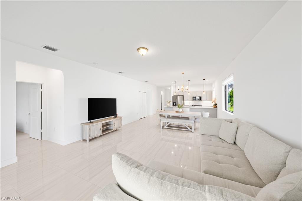 4951 Brigata Way Avenue Immokalee, FL 34142 - Photo 9 of 49 a living room with furniture and a flat screen tv