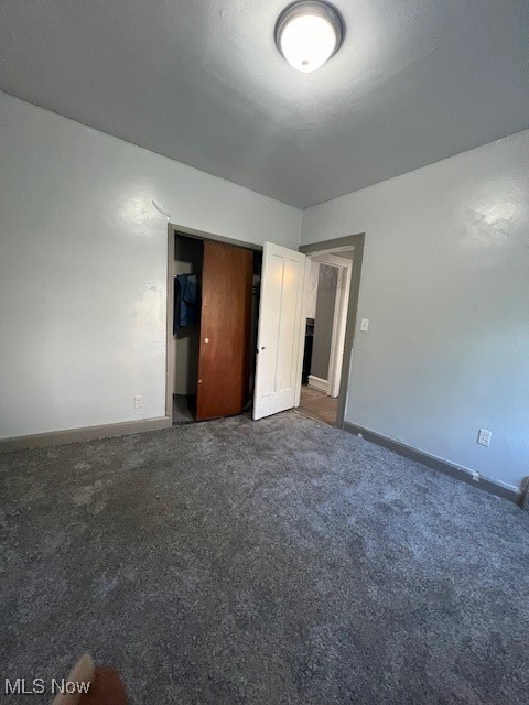 1842 Colonnade Road Cleveland, OH 44112 - Photo 8 of 47 Unfurnished bedroom featuring dark carpet and a closet