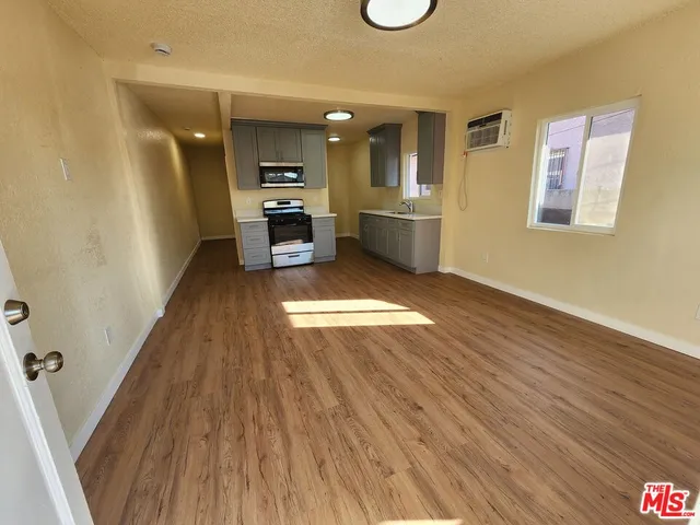 a view of kitchen with cabinets and wooden floor
