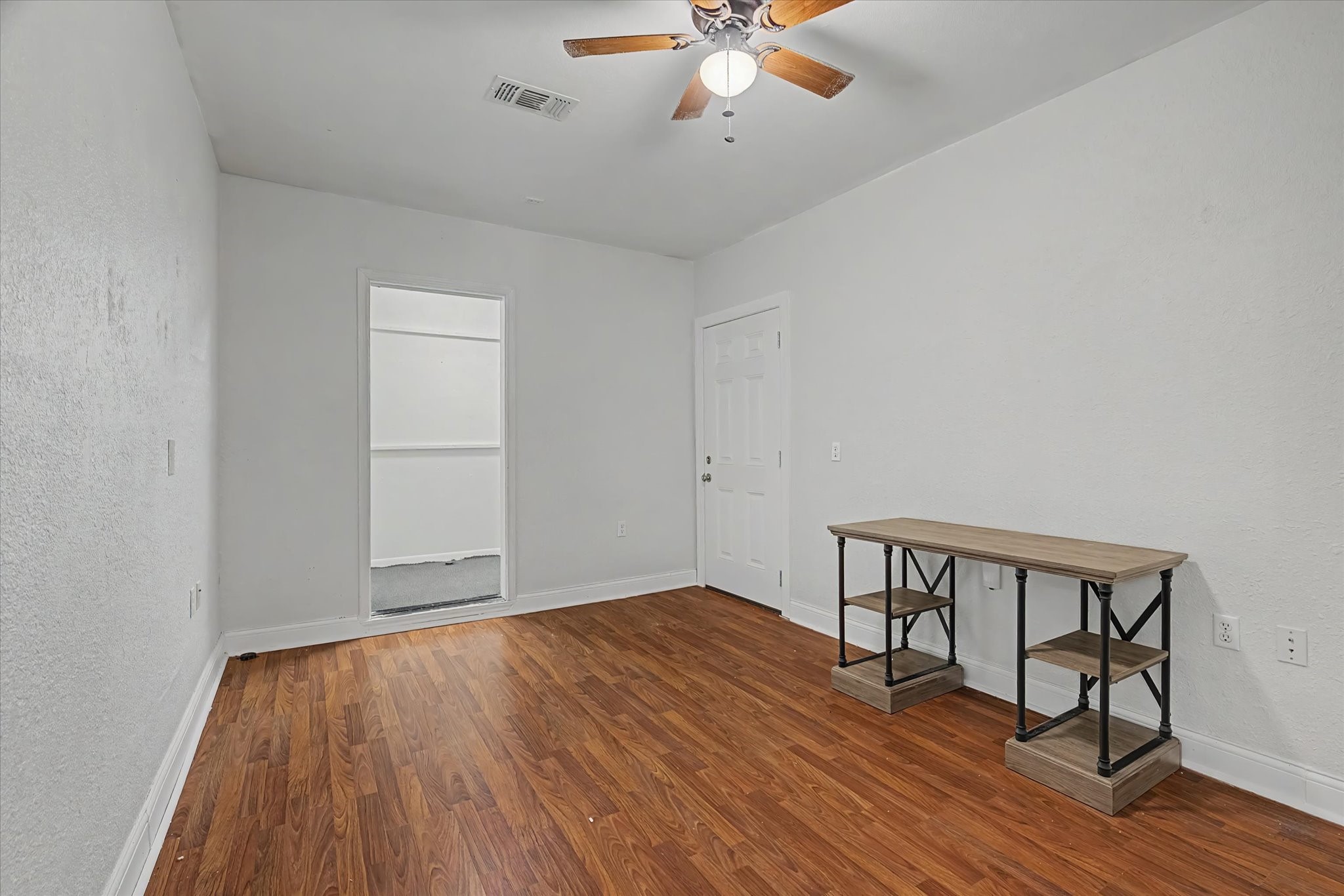 413 Farrer Street Angleton, TX 77515 - Photo 21 of 43 a view of room with hardwood floor and ceiling fan