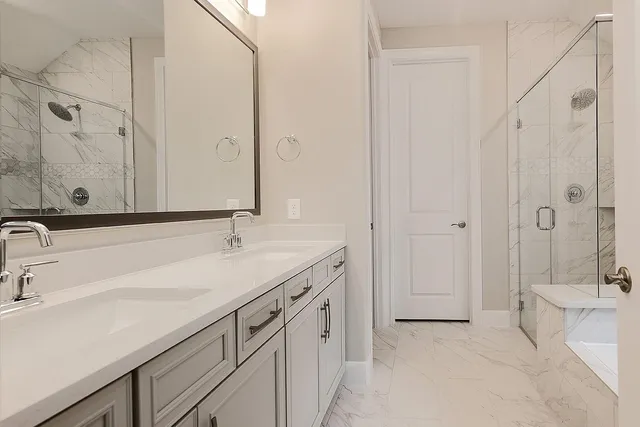 a bathroom with a double vanity sink and mirror with shower