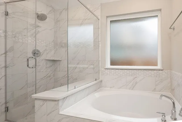 a white bath tub sitting next to a shower