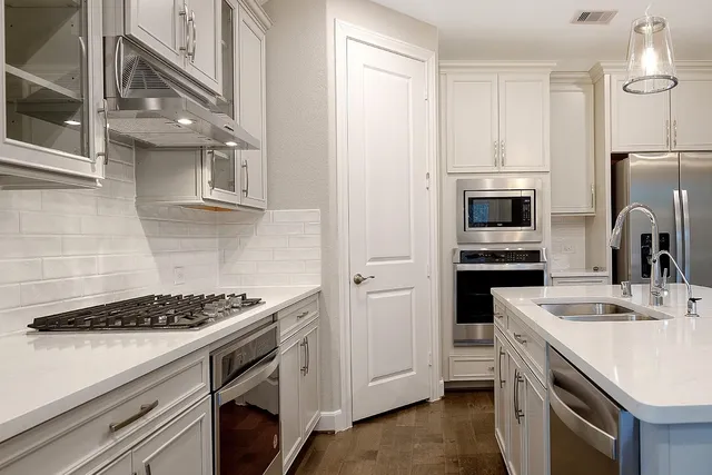 a kitchen with a sink stove and refrigerator