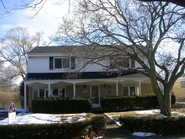 607 Elmhurst Road Mount Prospect, IL 60056 - Photo 1 of 24 a front view of a house with a yard