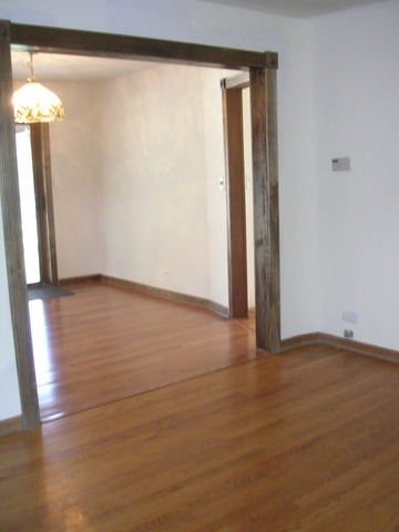 607 Elmhurst Road Mount Prospect, IL 60056 - Photo 19 of 24 a view of an empty room with wooden floor and a window
