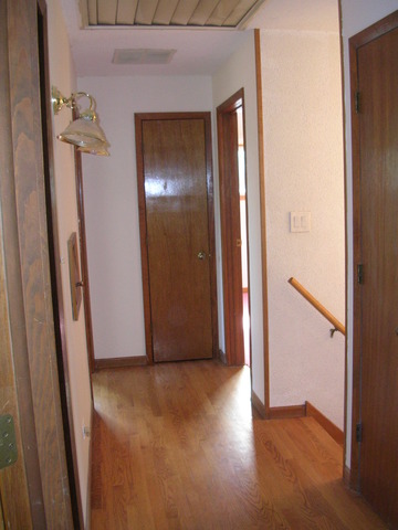 607 Elmhurst Road Mount Prospect, IL 60056 - Photo 21 of 24 an empty room with wooden floor and entrance