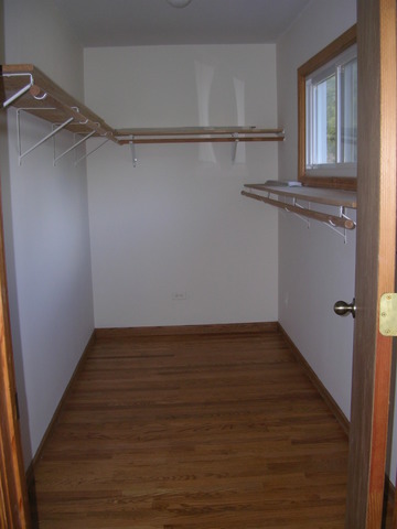 607 Elmhurst Road Mount Prospect, IL 60056 - Photo 24 of 24 a view of a room with an empty space and wooden floor