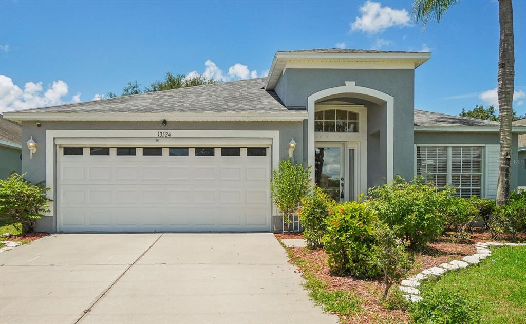 13524 Fladgate Mark Drive Riverview, FL 33579 - Photo 1 of 1 a front view of a house with garden
