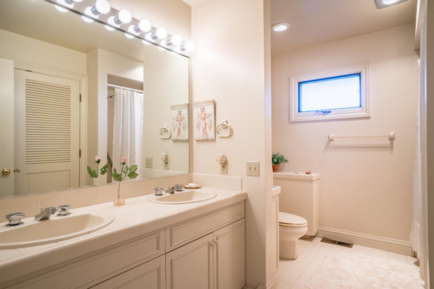 3011 Cormorant Road Pebble Beach, CA 93953 - Photo 22 of 37 a bathroom with a toilet a sink and mirror