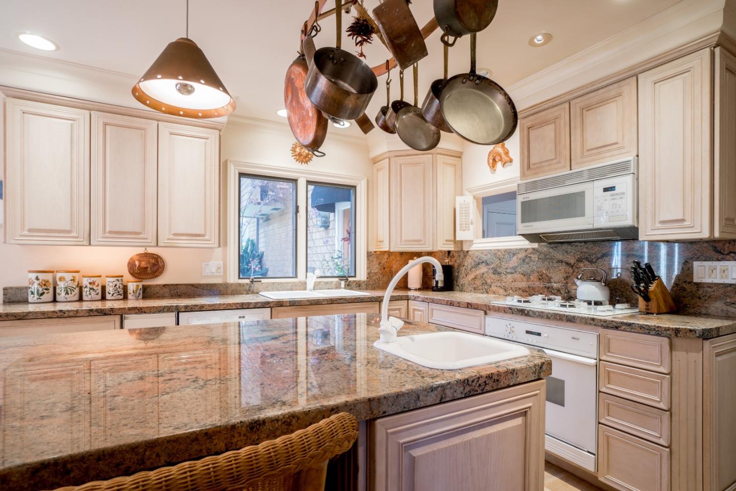 3011 Cormorant Road Pebble Beach, CA 93953 - Photo 9 of 37 a kitchen with stainless steel appliances granite countertop a sink a stove and cabinets