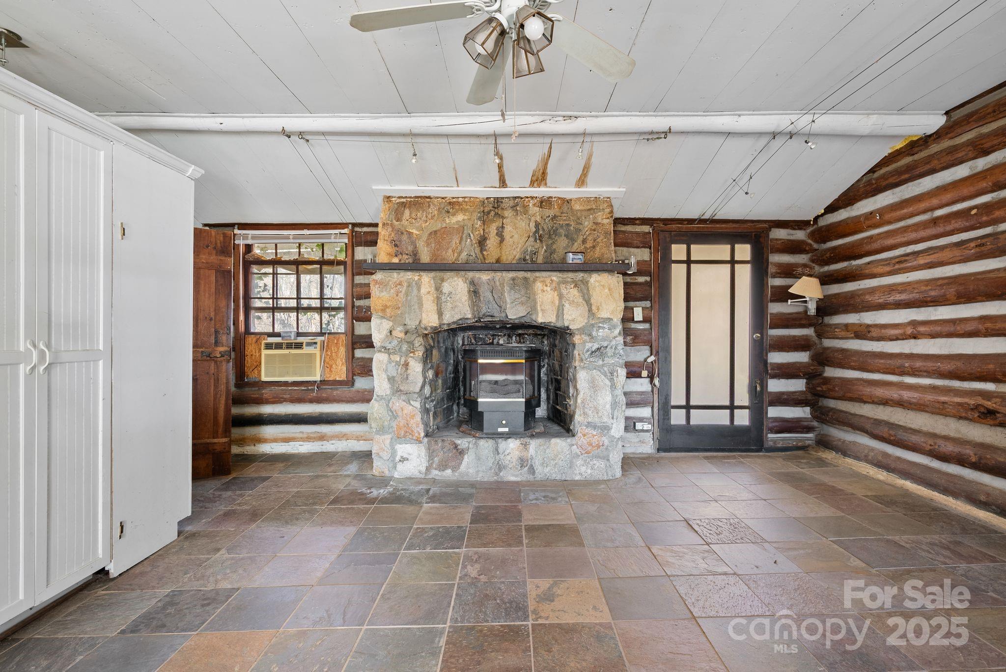 849 South Ammons Branch Road Marshall, NC 28753 - Photo 6 of 20 a view of an empty room with a fireplace and a window