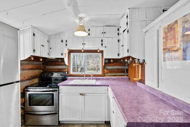 a kitchen with stainless steel appliances granite countertop a stove and a refrigerator