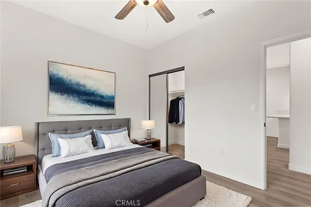 a bedroom with a bed and a painting on the wall