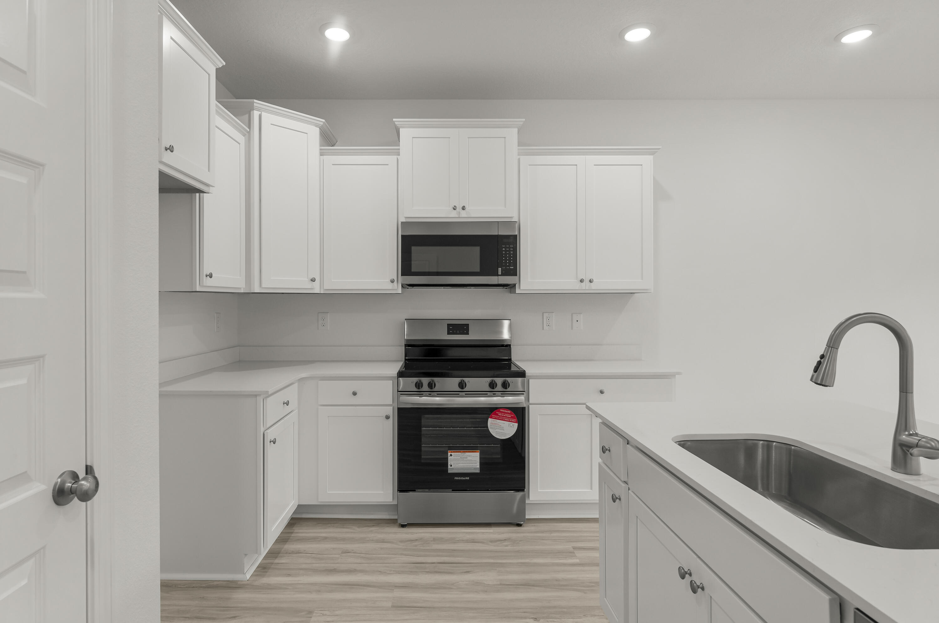 106 Hawk Street Santa Rosa Beach, FL 32459 - Photo 5 of 21 a kitchen with white cabinets appliances and a sink