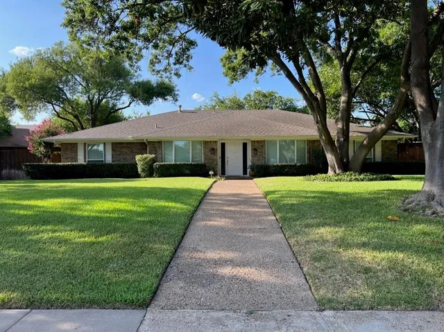 a view of house that has a yard