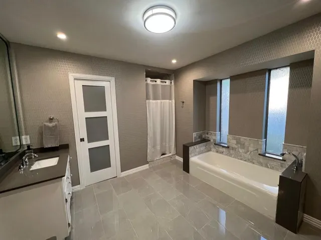 a spacious bathroom with a double vanity sink and mirror