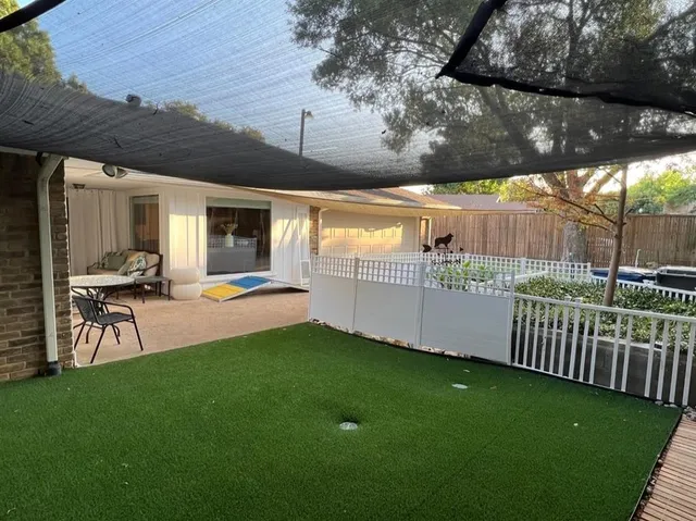 a view of a backyard with sitting area