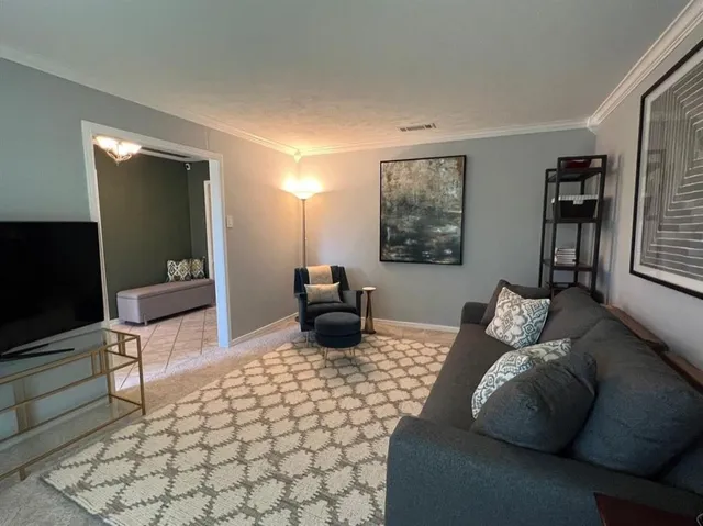 a bedroom with furniture and a flat screen tv