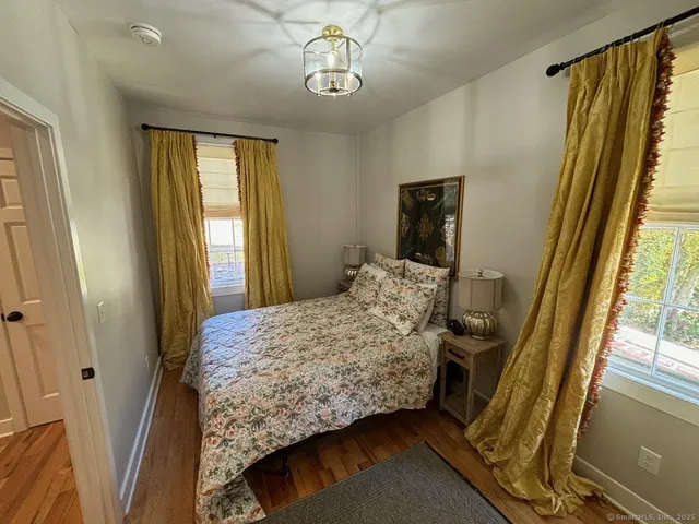 a bedroom with a bed window and a mirror