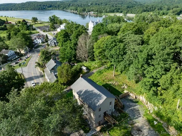 an aerial view of a house with a yard