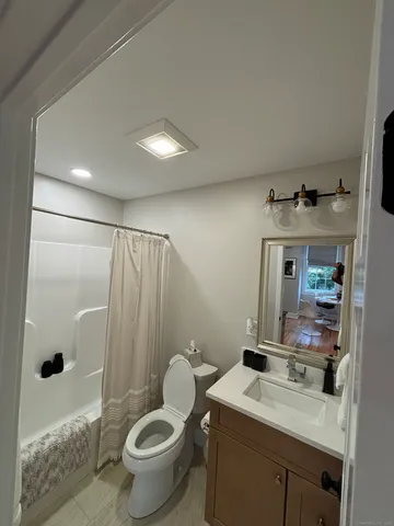 a bathroom with a sink toilet and shower