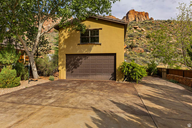 105 River Bend Circle, Unit 105 Springdale, UT 84767 - Photo 40 of 56 Stucco exterior with a two-car garage and a paved driveway