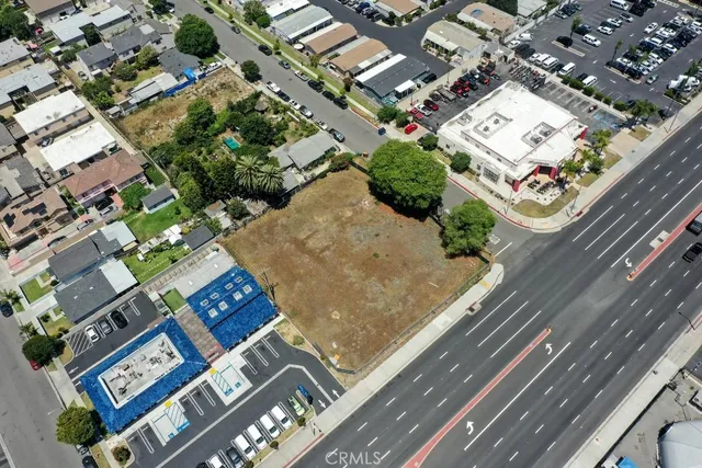 an aerial view of a multi story building with yard