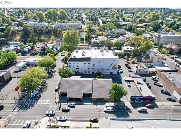 an aerial view of residential houses with outdoor space and parking