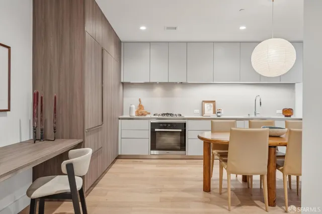 a kitchen with a table chairs sink and cabinets