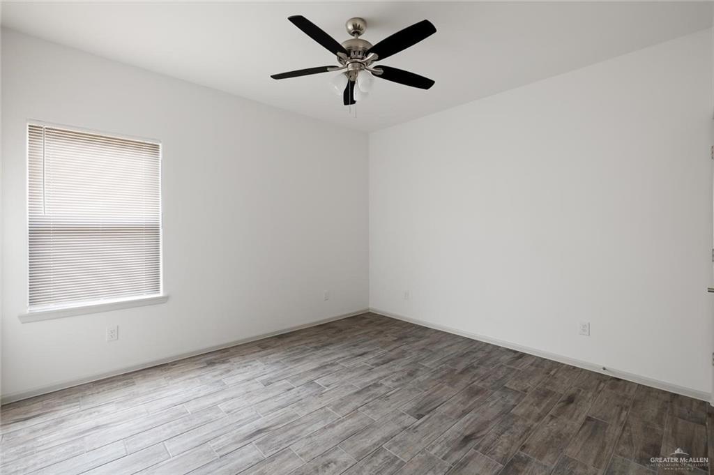 1020 Palm Drive, Unit 1 Alamo, TX 78516 - Photo 9 of 9 an empty room with a window and a fan